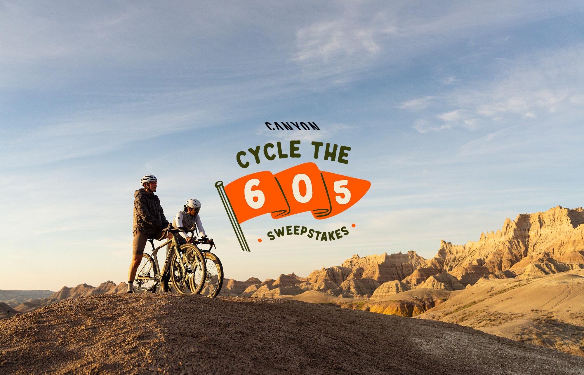 Two Canyon riders overlooking the Badlands with the Cycle the 605 lockup.