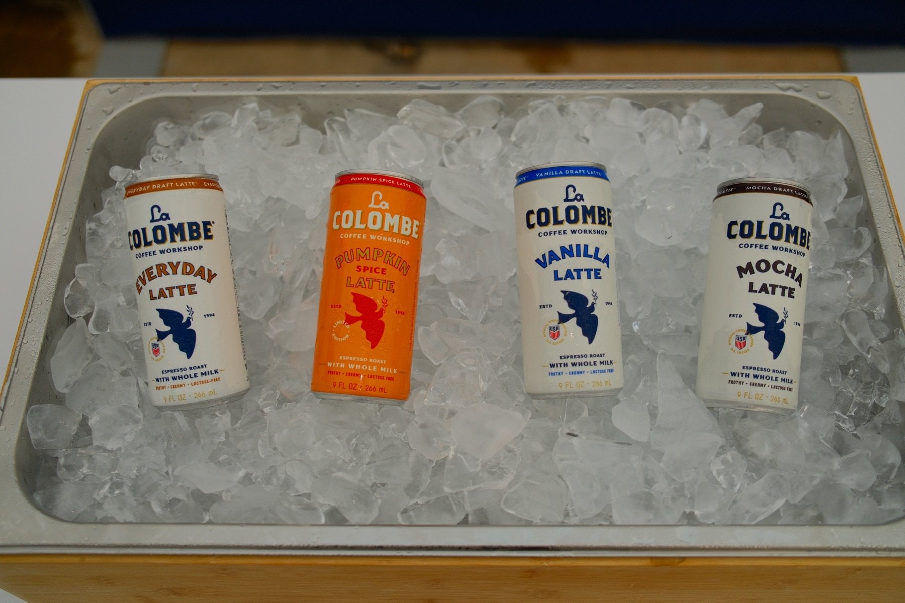 Everyday, Pumpkin Spice, Vanilla, and Mocha Draft Latte cans on ice.